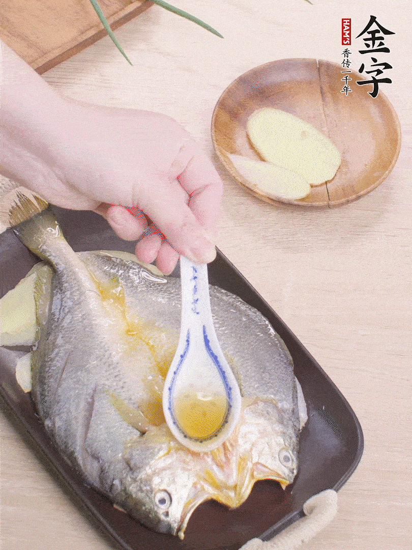 盤(pán)底鋪姜片，放黃魚(yú)，淋2勺料酒。