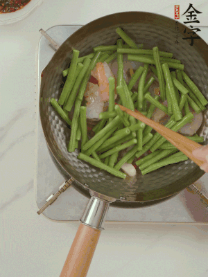 下掰好的缸豆段翻炒，略燜煮。